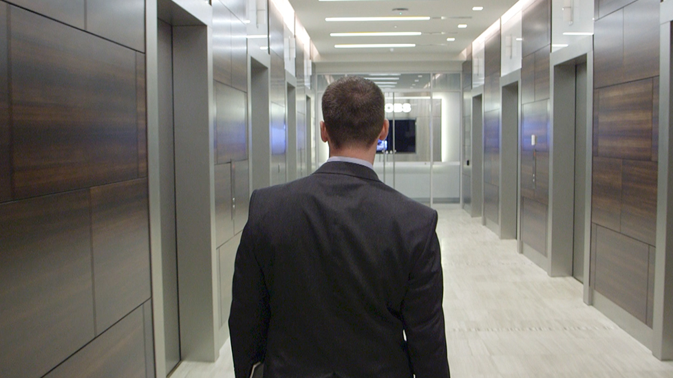 businessman walking down hallway