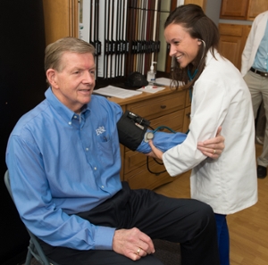 Robert Plumber, owner of RP Lumber, receives a blood pressure screening