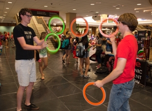 Jugglers demonstrate their talents while gaining the attention of potential new members.