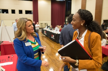 Shelley Williams with the SIUE School of Business (L) discusses the master’s in business administration with Paula Clarke, of Chicago.
