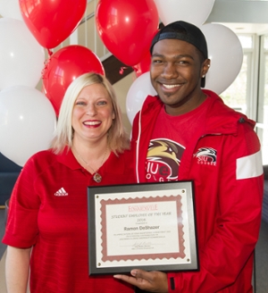Jennifer Hoxsey helps Ramon DeShazer celebrate his recognition as Student Employee of the Year.