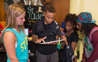 Student Leslie Hardin signs up to learn more information about St. Jude Up ‘til Dawn. Looking on are fellow students (L-R) Kayley Stock, executive board member, and Taylor Sallis and Daniel Sims.