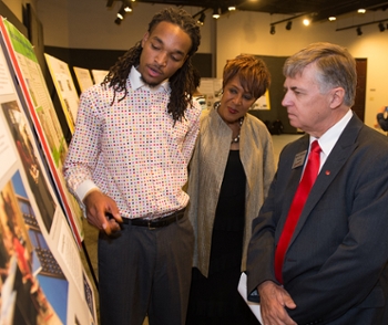 SIUE pre-pharmacy student Christian Wells describes his internship experience to Earleen Patterson, director of Student Opportunities for Academic Results (SOAR), and Chancellor Dr. Randy Pembrook.