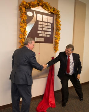 Chris Smith, president and CEO of H.D. Smith and current chair of the School’s Pharmacy Advisory Board, and SIUE Chancellor Dr. Randy Pembrook, shake hands after unveiling the leadership wall.