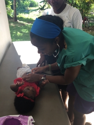 SIUE School of Nursing’s Chontay McKay, cares for an infant during a clinical visit in Jacmel, Haiti.