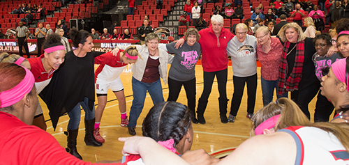 Breast cancer survivors join the SIUE women’s basketball team in celebration ahead of the game against Jacksonville State.