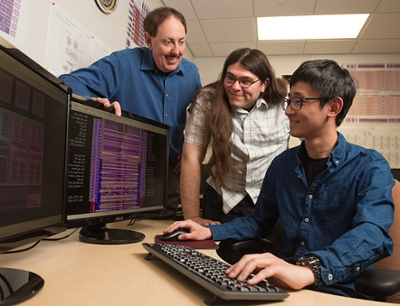 SIUE Graduate student Pohan Wang, of Taiwan, is seated in the research lab, with fellow student Bryan Orabutt, of Springfield, and Dr. George Engel (back), looking on.