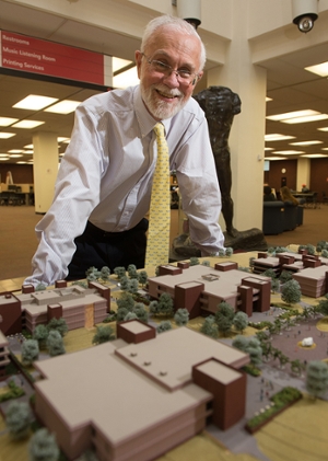 University Archivist Steve Kerber admires the original scale model of the SIUE campus on display in Lovejoy Library.