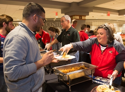 Provost and Vice Chancellor for Academic Affairs Denise Cobb smiles as she serves breakfast to graduate student Uday Vettigunta.