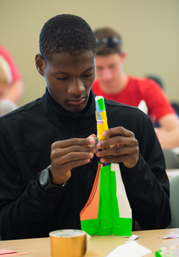 Jamaine Owens, a senior at East St. Louis Charter High School, builds a rocket during SIUE Engineering Camp.