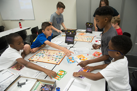 Participants in SIUE’s We Got Game: NBA Math Hoops camp work together to enhance their math skills through interactive learning. 