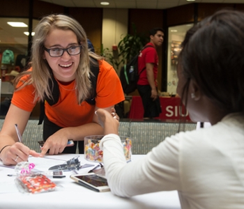 Kassie Jeralds, of pre-pharmacy major from Royalton, signs up to learn more about G.I.R.L., a new student organization founded by junior mass communications major Dejanee Callahan.