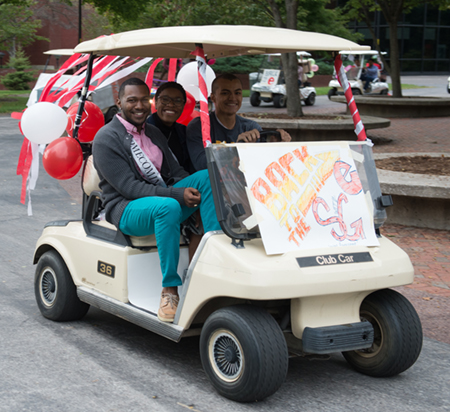 Students participate in the golf cart parade during Homecoming.
