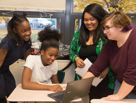 (L-R) Middle school students from Madison, Monique Wright and Karmen Jackson, work with SIUE students Shervonti Norman and Gabrielle Borders during Digital Humanities Club.
