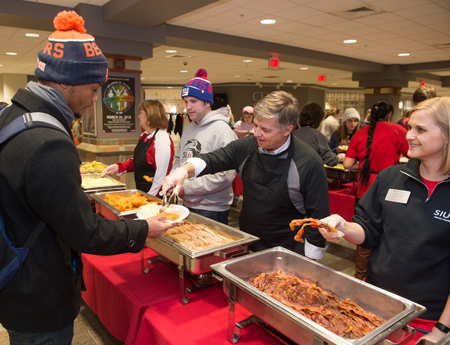 SIUE Chancellor Randy Pembrook serves junior Nicholas Haley, of Springfield, during the late night breakfast.