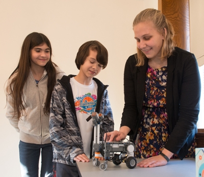 (L-R) Edwardsville students Mercedes Mueller and Maximus Mueller, along with Jessica Tetzner, a sophomore studying computer science in the SIUE School of Engineering, demonstrated robotics for attendees touring the Alma Irene Aitch STEM Center.