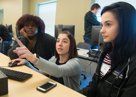 SIUE alumna Darla Ahlert, MS’15, (middle) offered assistance as Radricka Kelly-Olden, of East St. Louis, (L) and Izabella Tognarelli, of Collinsville, (R) worked together to create a mobile application during SIUE’s SheCode event.
