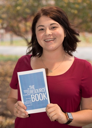Rachel Thurston, the first graduate of SIUE’s undergraduate international studies program, holds the resource book she created for area immigrants and refugees. She will earn her bachelor’s on Saturday, Dec. 16 during SIUE’s Fall 2017 commencement ceremony.
