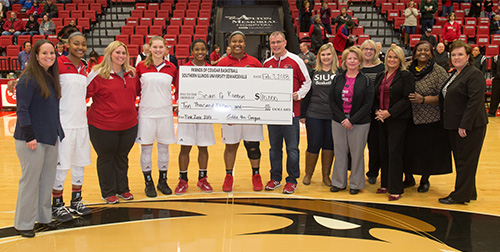 SIUE Women's Basketball and the Pink Zone committee present a check for $10,000 to Susan G. Komen Missouri.
