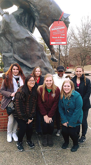 Members of SIUE's Students Today, Alumni Tomorrow (STAT) organization stand on campus, as they promote the February Thank-A-Giver campaign.