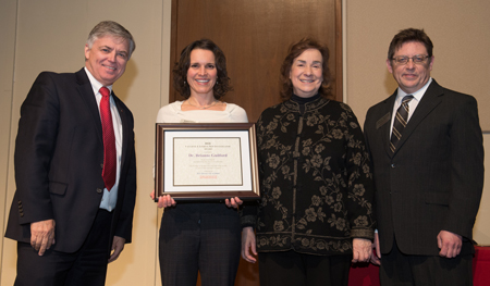 (L-R) SIUE Chancellor Randy Pembrook, 2018-19 Vaughnie Lindsay New Investigator Award recipient Dr. Brianne Guilford, Sandy Doreson, daughter of the late Dr. Vaughnie Lindsay, and Dr. Jerry Weinberg.