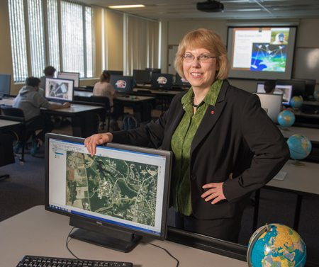 SIUE College of Arts and Sciences Department of Geography Chair Susan Hume, PhD, stands in the University's Geospatial Technology Lab.