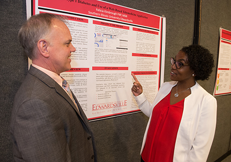 SIUE School of Nursing DNP program graduate Felicia Kimbrough presents her practice project to Assistant Dean for Graduate Programs Andrew Griffin.