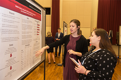 SIUE School of Pharmacy's Maddie VanDaele presents her research at an SIUE event.
