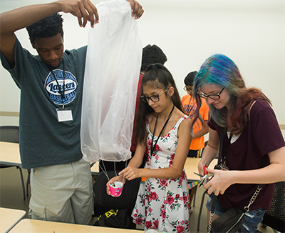 (L-R) Jalen Rhodes, of Belleville, works on a project with Josie Garcia, of Chicago, and Mikayla McMullin, of Wheaton.