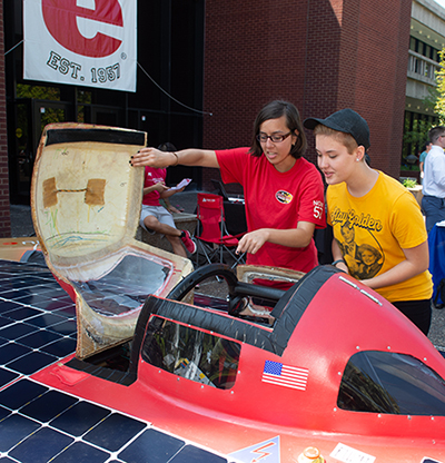 (L-R) Sophomore Jacqueline Corral shows sophomore Sara Simpson SIUE’s Solar Car and encourages her to get involved.