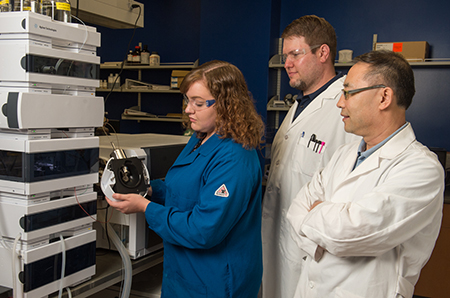 Graduate student Samantha Wilhelm works with equipment that has enhanced the research productivity of SIUE’s Drs. Tucker (middle) and Lu (right). 