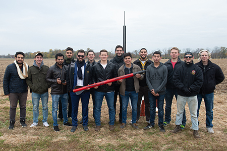 Charter members of SIUE’s new Cougar Rockets organization, and their faculty advisor Michael Denn (far right) celebrate their first launch. 