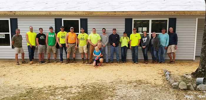 Members of the SIUE Constructor’s Club volunteered their time building houses in Florida during the University’s spring break. Pictured here are the SIUE volunteers, along with core volunteers from Habitat for Humanity and the homeowner.