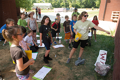 Super Sleuths at Odyssey Science Camp learn about collecting evidence during an outdoor camp session.