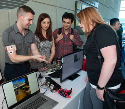A team of mechatronics and robotics students show the robotic prosthetic arm they created during the School of Engineering’s Senior Design Project Competition.