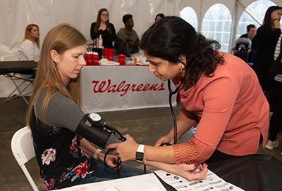 Third-year School of Pharmacy student Smita Rausaria checks the blood pressure of event participant Sue Slimack, of Belleville.