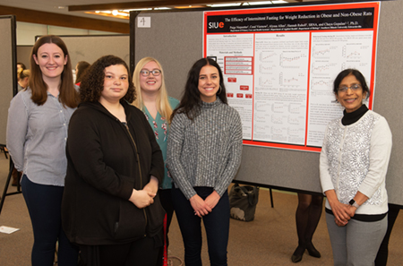Dr. Chaya Gopalan (right) stands with members of her research team, including (L-R) Hannah Ruholl, Alyssa Allen, Paige Niepoetter and Coral Viemow.