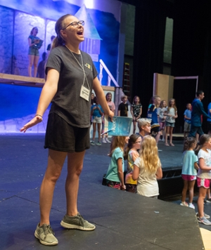 London Radstone, who plays Anna, happily practices a song during a stage rehearsal.
