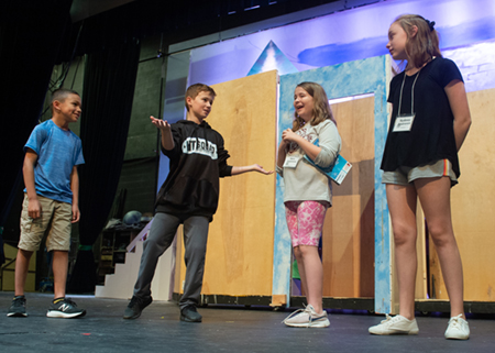 (L-R) Mark Hill, Charlie Houle, Nora Cummins and Sydney Andrews practice a scene from Frozen, Jr.