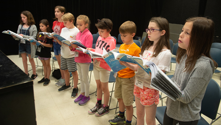 A group of camp participants sing during their voice sectionals.