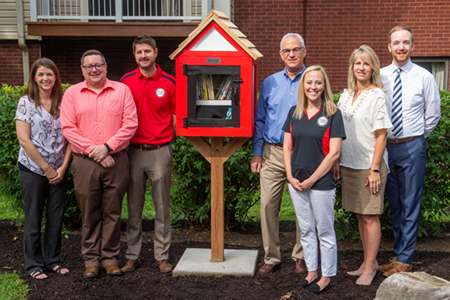 Among those involved in the Little Free Library’s donation and installation are (L-R) University Housing Interim Director Mallory Sidarous, Associate Director of Residence Life Rex Jackson, Alumni Association Board Member Ryan Downey, Former University Housing Director Michael Schultz, Alumni Association President Eileen Martindale, Director of Constituent Relations and Special Projects Cathy Taylor, and Assistant Director of Constituent Relations Nick Niemerg.