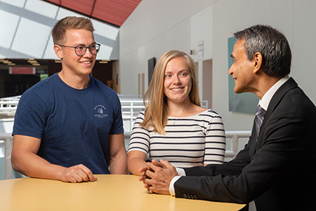 Visiting German students (L-R) Kristoffer Schweizer and Julia Triesch engage with SIUE finance professor Dr. Rakesh Bharati while on campus for the School of Business’s Summer Financial Institute.