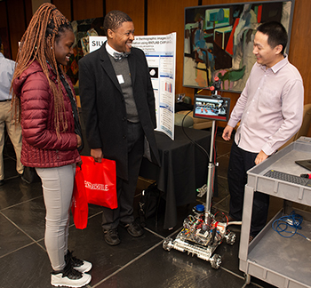 A student showcases his innovative research project to interested attendees at the 2019 Graduate School Research Symposium.