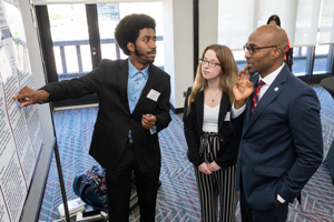 Students explain their research to SIUE Chancellor James T. Minor, PhD. 