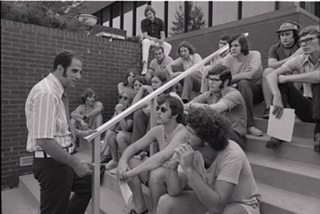 Photo: Dr. Jack Shaheen leads a course on the stairs of SIUE’s Dunham Hall in September 1972. Photo Credit: Bowen Archives, Southern Illinois University Edwardsville