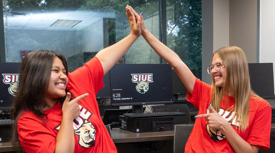 SIUE students high five.