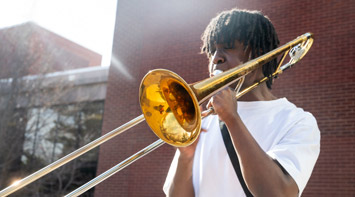 SIUE student plays a musical instrument.