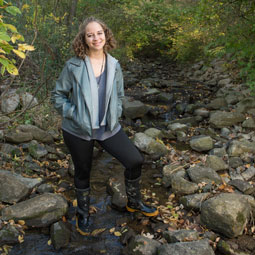 Geography student standing on rocks at SIUE