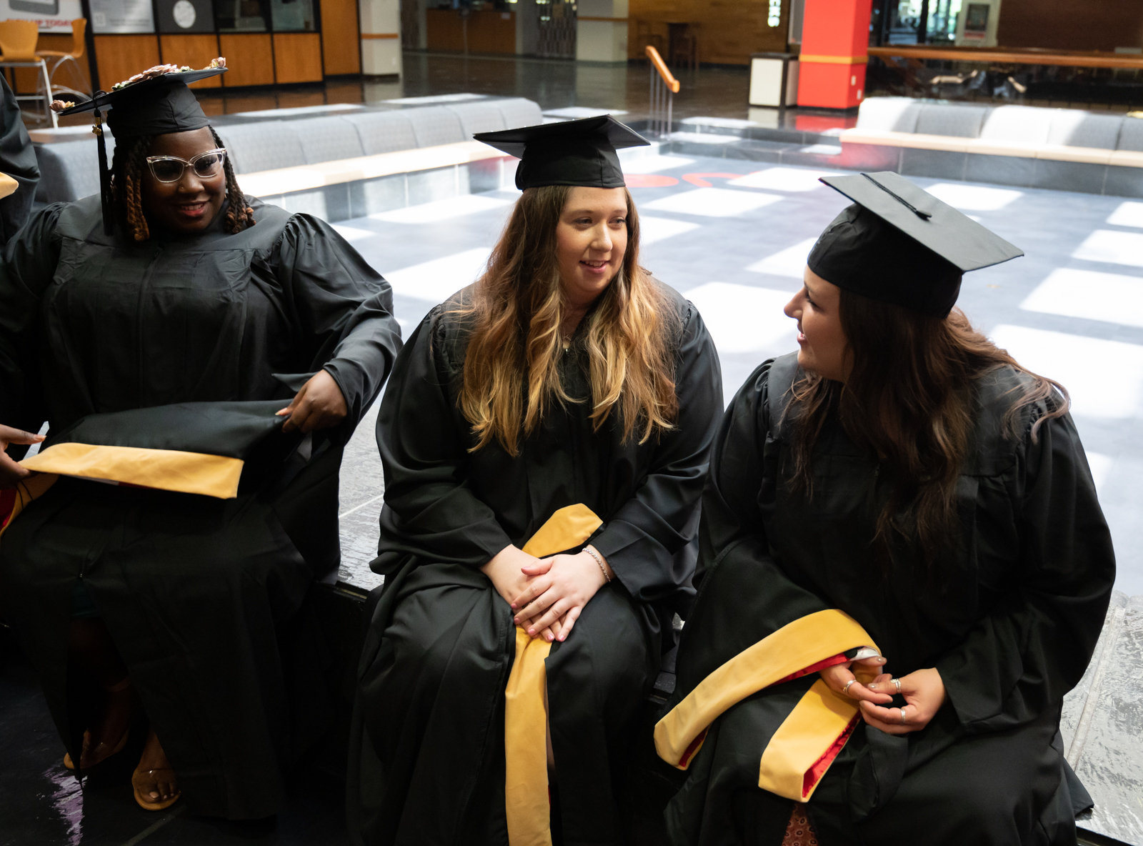 A group of graduating MSW students in caps and gowns.