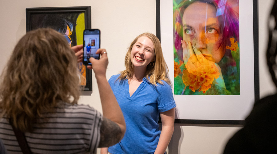 SIUE Student taking a picture in front of an email.